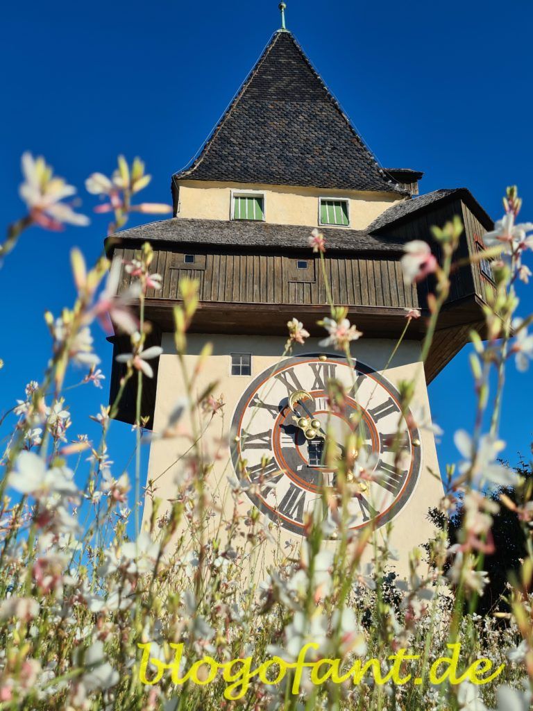 Ein Wochenende in Graz: Dein ultimativer 48-Stunden-Reiseführer 23 Grazer Schloßberg mit Uhrturm und Blumen im Herbst, Uhrturm Graz, Blumen in Graz, Herbst in Graz